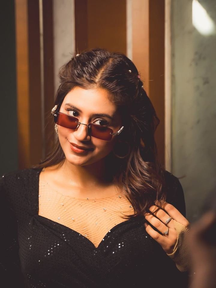 Anjali Arora — nightclub appearance | TKC Talent Anjali Arora smiling in a black sequinned outfit with tinted sunglasses at a nightlife event booking handled by TKC Talent.