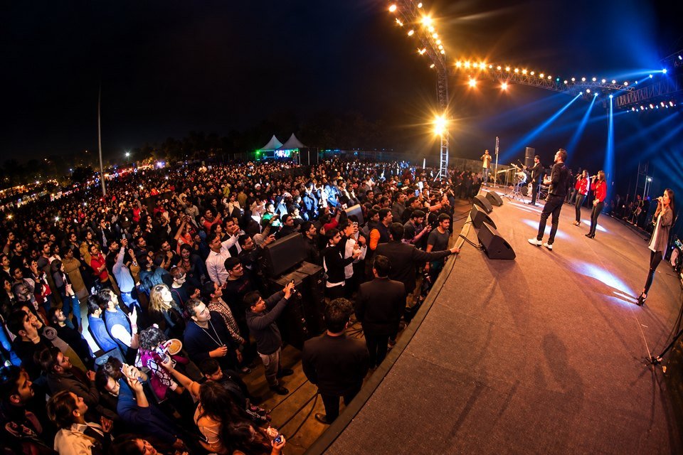 Large audience in front of a main stage at an event produced by TKC Talent Large audience in front of a main stage at an event produced by TKC Talent