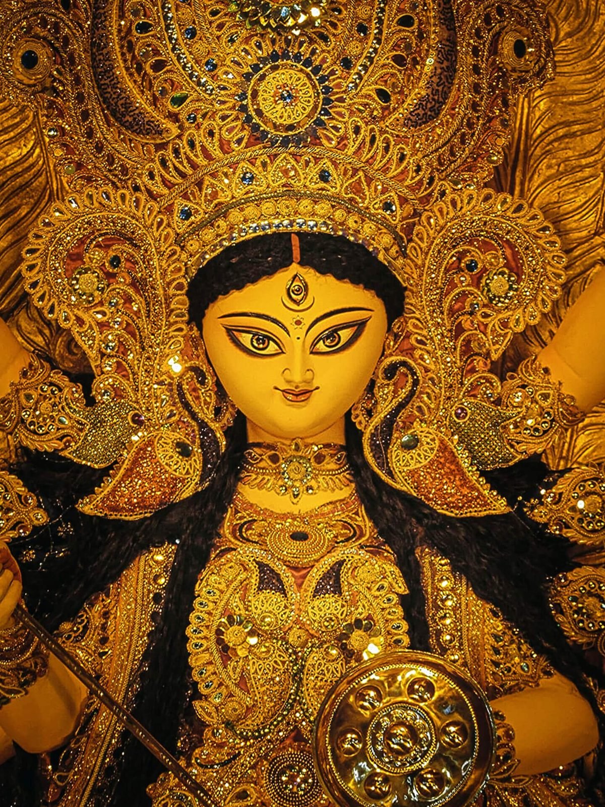 Close-up of Durga Maa's face with traditional chalchitra crown at CR Park Durga Puja 2026 Close-up of Durga Maa's face with traditional chalchitra crown at CR Park Durga Puja 2026